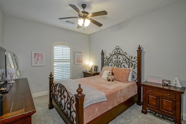 bedroom with baseboards, light carpet, a ceiling fan, and visible vents
