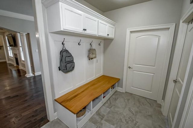 mudroom with baseboards, decorative columns, ornamental molding, and wood finished floors