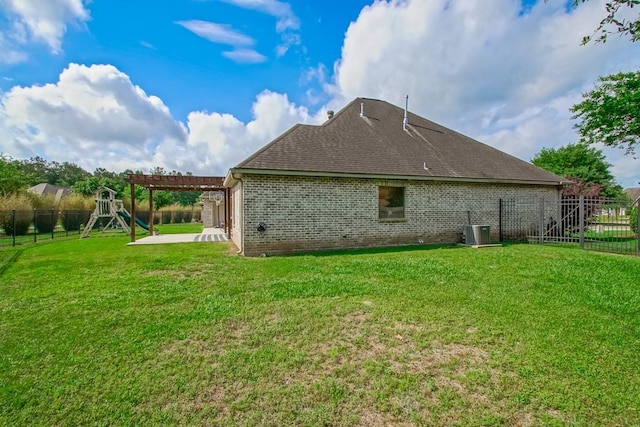 rear view of house featuring a fenced backyard, central AC unit, a patio area, a playground, and a lawn