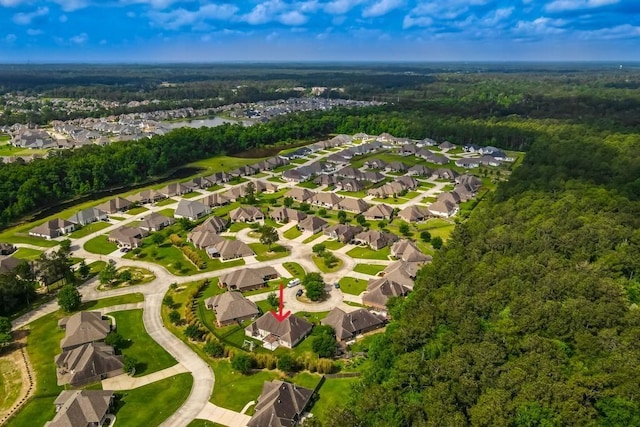 bird's eye view featuring a residential view and a wooded view