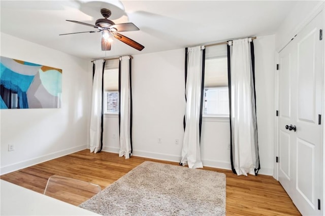 6565 Milne Blvd, New Orleans, LA 70124 - unfurnished bedroom featuring multiple windows, light wood finished floors, baseboards, and a ceiling fan