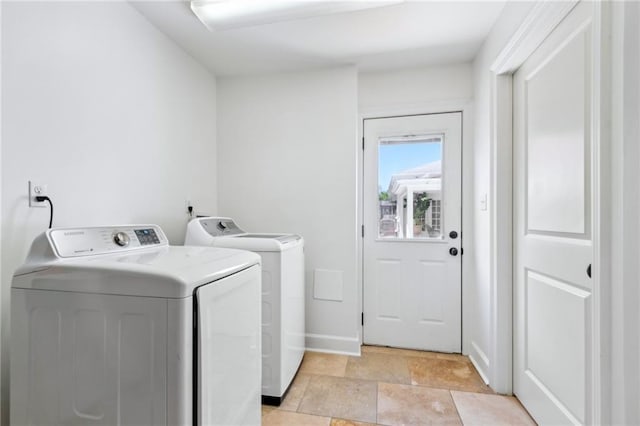 6565 Milne Blvd, New Orleans, LA 70124 - washroom with washer and clothes dryer, light stone finish flooring, and baseboards