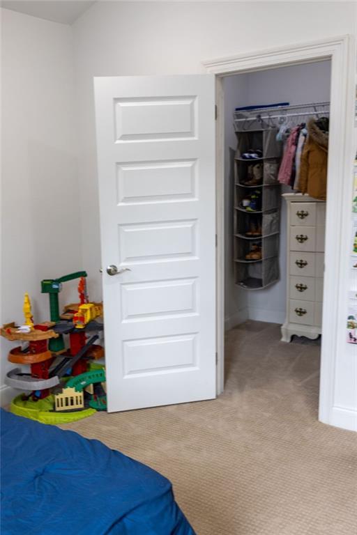 109COUSHATTACIRCLE Coushatta Cir, Madisonville, LA 70447 - bedroom featuring light colored carpet, a closet, and a spacious closet