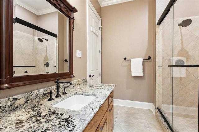 bathroom featuring baseboards, ornamental molding, a shower stall, and vanity