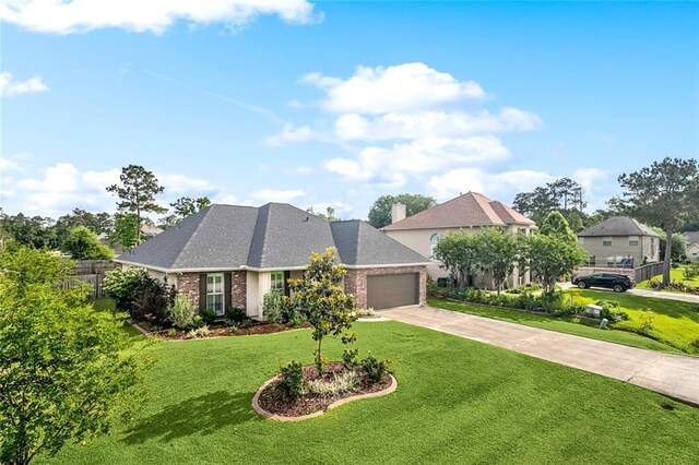 view of front of property featuring brick siding, driveway, a front yard, and a garage