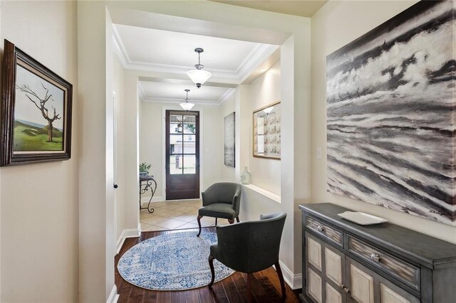 interior space featuring crown molding, baseboards, and wood finished floors
