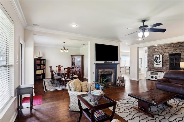 living area with a fireplace with flush hearth, crown molding, ceiling fan with notable chandelier, and hardwood / wood-style floors
