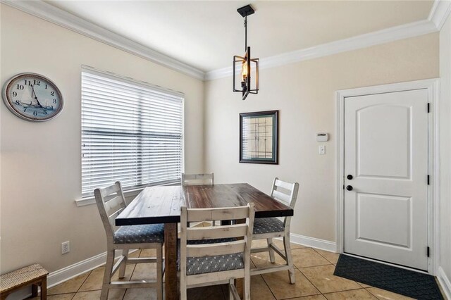 dining area featuring light tile patterned floors, baseboards, and crown molding