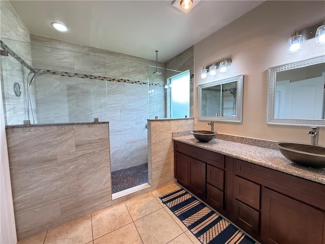 bathroom featuring a sink, a walk in shower, and tile patterned flooring
