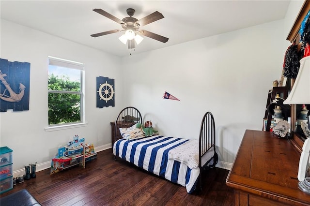bedroom with a ceiling fan, baseboards, and wood finished floors