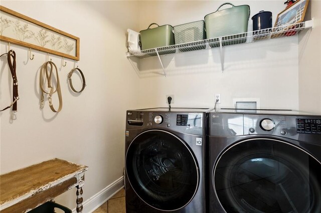 laundry area featuring baseboards, tile patterned flooring, laundry area, and independent washer and dryer