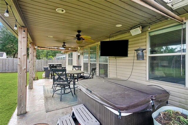 view of patio / terrace with outdoor dining area, ceiling fan, a hot tub, and fence