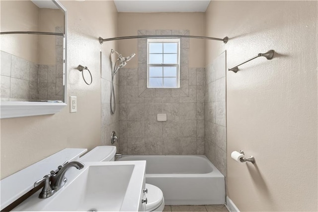 full bath featuring a sink, tile patterned floors, bathing tub / shower combination, and toilet
