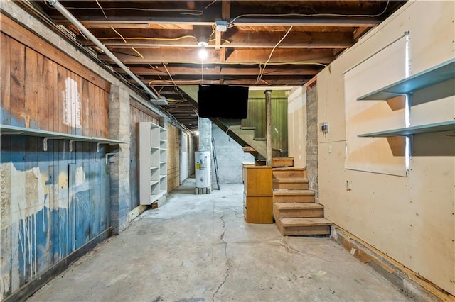 unfinished below grade area with water heater and stairway