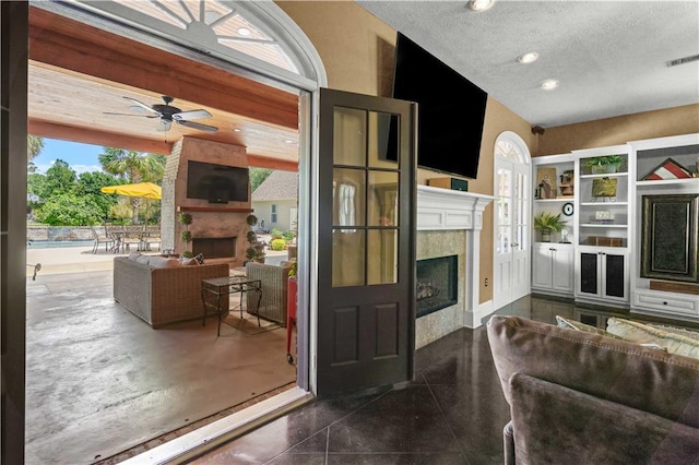 364 Winchester Cir, Mandeville, LA 70448 - living area featuring ceiling fan, a textured ceiling, visible vents, a fireplace, and recessed lighting