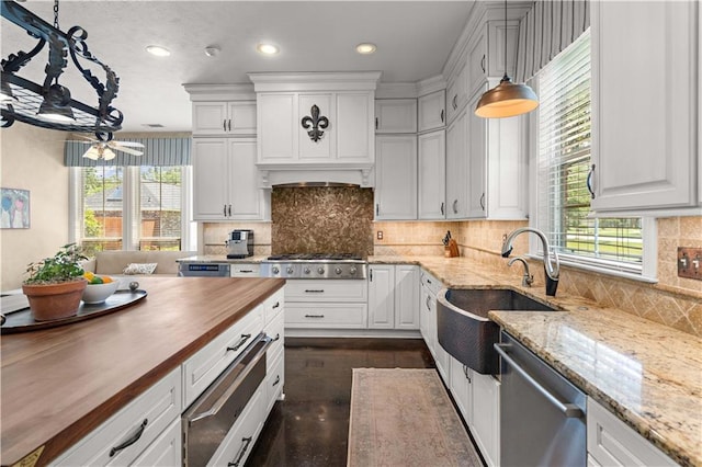 364 Winchester Cir, Mandeville, LA 70448 - kitchen with white cabinets, a sink, wood counters, a warming drawer, and stainless steel appliances