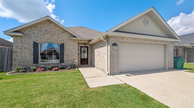 single story home featuring brick siding, a front lawn, an attached garage, and concrete driveway