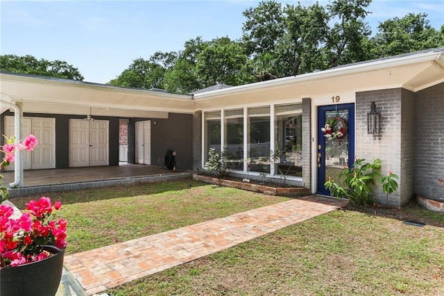 19 Rail St, New Orleans, LA 70124 - doorway to property featuring brick siding, a lawn, and covered porch
