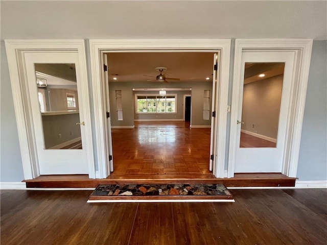 hall with baseboards and parquet floors
