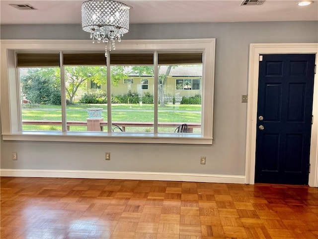 entrance foyer featuring a healthy amount of sunlight, baseboards, and visible vents