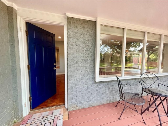 entrance to property featuring brick siding