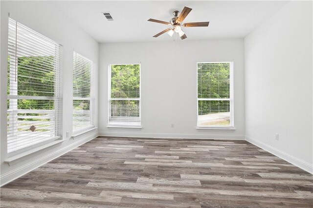 unfurnished room with a healthy amount of sunlight and baseboards