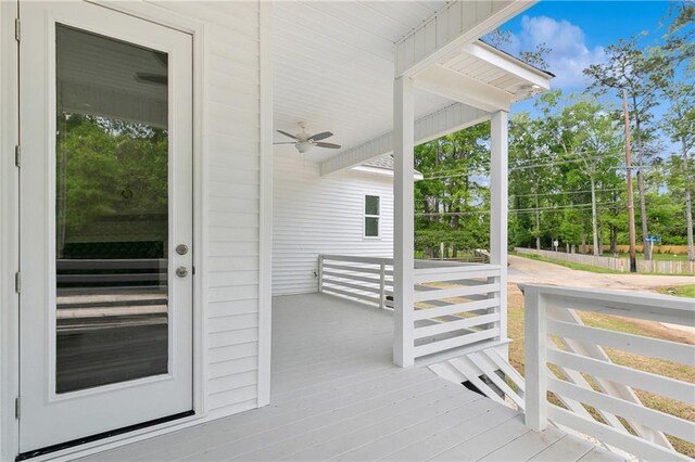 property entrance with a ceiling fan and covered porch