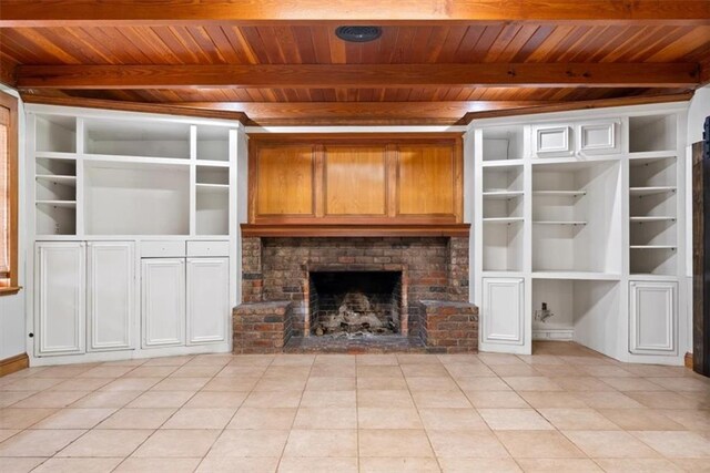 unfurnished living room with a fireplace, wood ceiling, beamed ceiling, and light tile patterned flooring