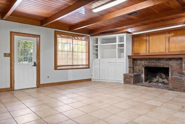 unfurnished living room with beam ceiling, a fireplace, baseboards, wooden ceiling, and light tile patterned floors
