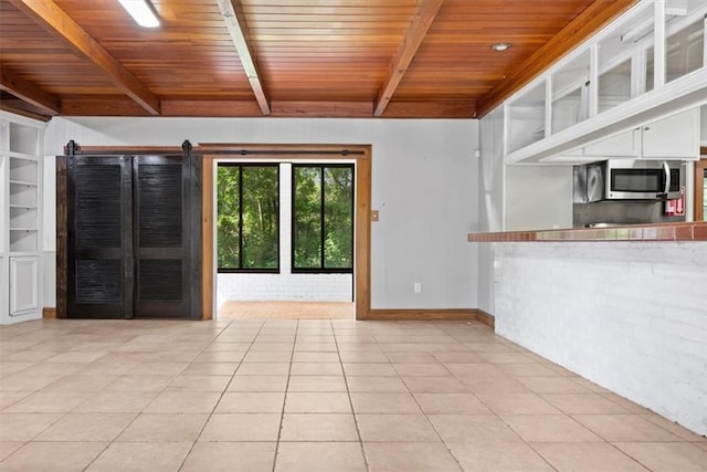 unfurnished living room featuring wood ceiling, baseboards, light tile patterned flooring, and beam ceiling