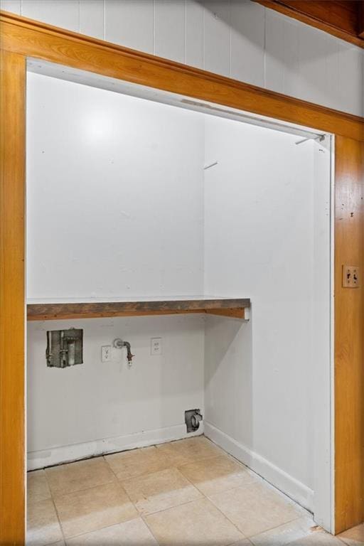 clothes washing area featuring washer hookup, baseboards, and tile patterned floors