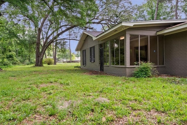 view of yard with a sunroom
