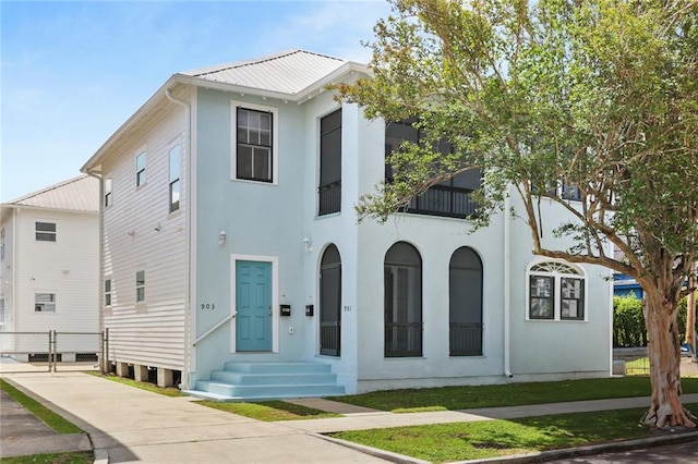 view of front facade with metal roof and stucco siding