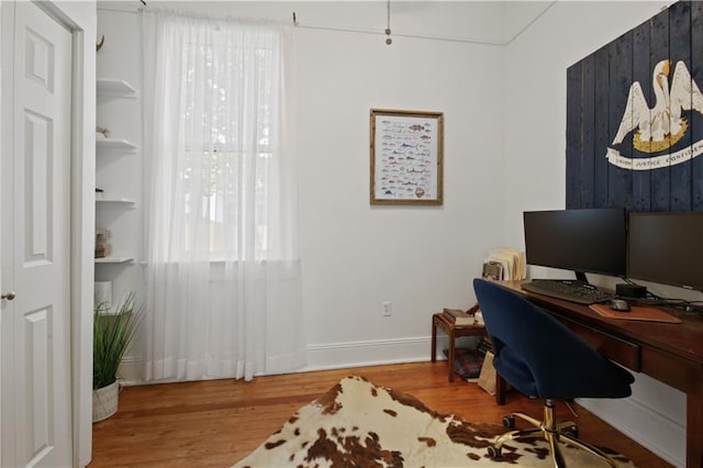 office featuring baseboards and wood finished floors