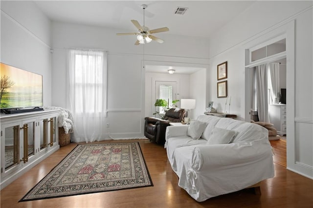 living room with ceiling fan and wood finished floors