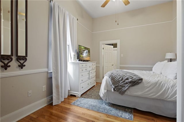 bedroom with wood-type flooring, baseboards, and ceiling fan