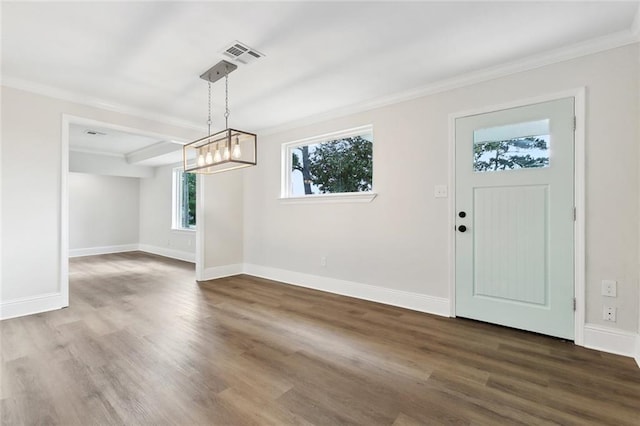 unfurnished dining area with baseboards, ornamental molding, wood finished floors, and visible vents