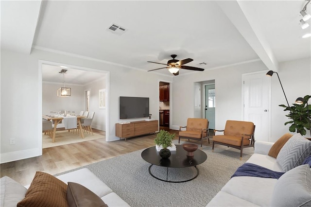 living room with a ceiling fan, baseboards, visible vents, and light wood-style flooring