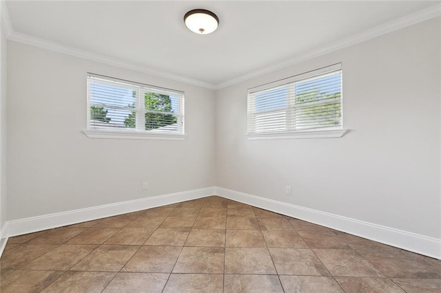 empty room featuring crown molding and baseboards