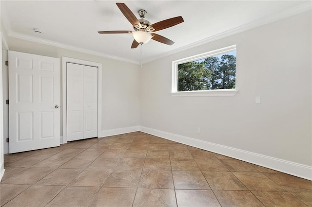 unfurnished bedroom with baseboards, ornamental molding, ceiling fan, and a closet