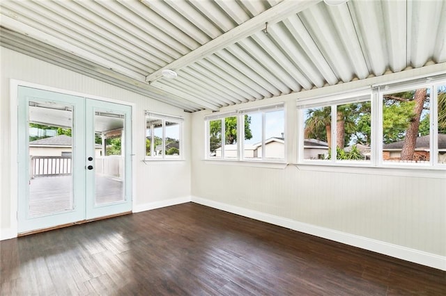 unfurnished sunroom featuring baseboards, lofted ceiling with beams, and french doors