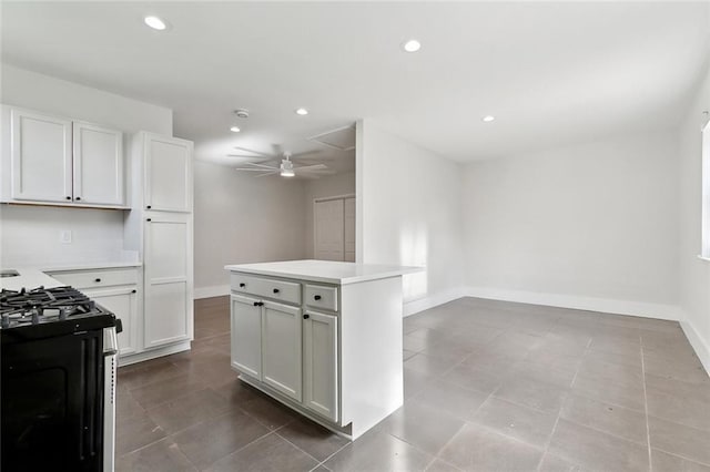 kitchen with stainless steel range with gas stovetop, a ceiling fan, recessed lighting, and light countertops