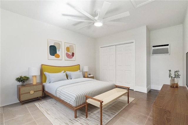 tiled bedroom with ceiling fan, a wall unit AC, and a closet