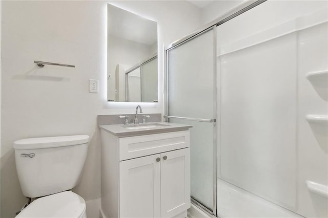 full bathroom featuring toilet, a shower stall, and vanity