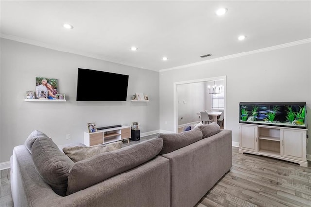 living room with ornamental molding, recessed lighting, and visible vents