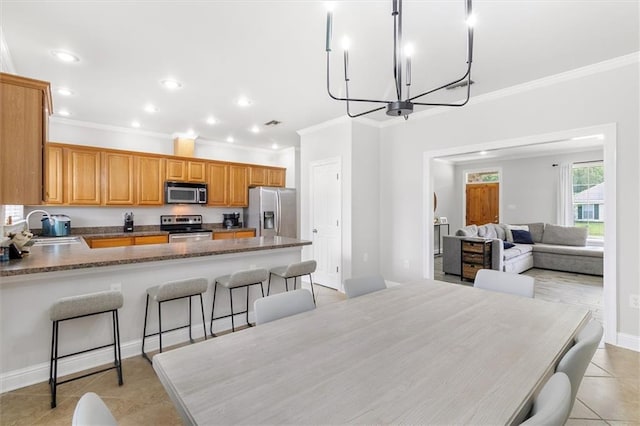 dining area featuring light tile patterned flooring, a chandelier, recessed lighting, baseboards, and ornamental molding