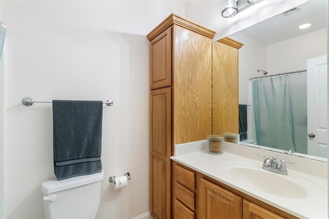 bathroom featuring vanity, visible vents, toilet, and a shower with shower curtain