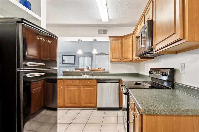 kitchen with visible vents, a sink, brown cabinetry, and black appliances