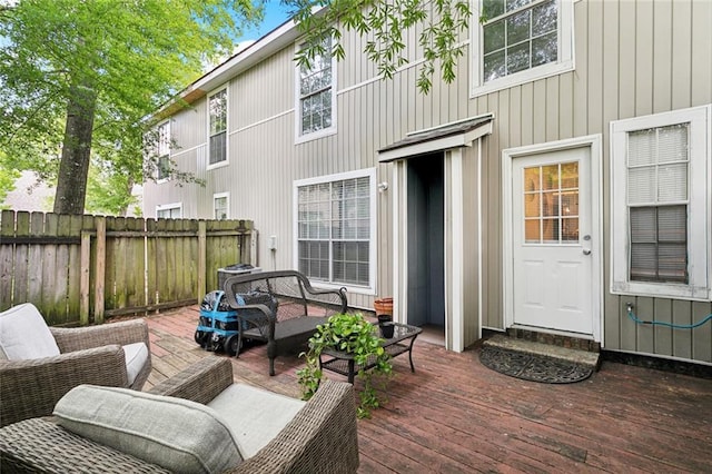 wooden deck with fence and an outdoor hangout area
