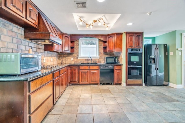 kitchen featuring backsplash, visible vents, a sink, light tile patterned floors, and black appliances